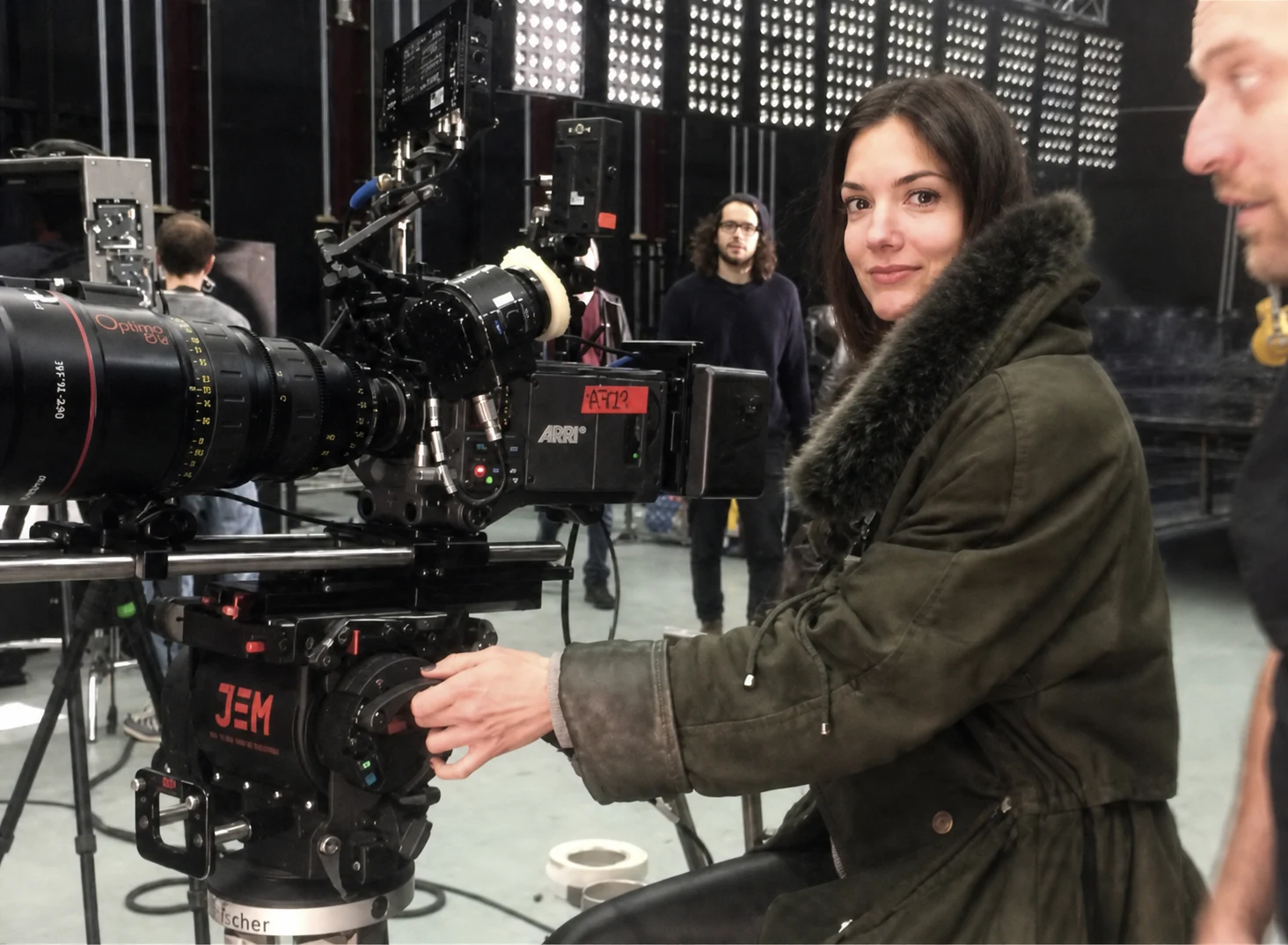 Ana Lario on set, behind an ARRI camera in a studio